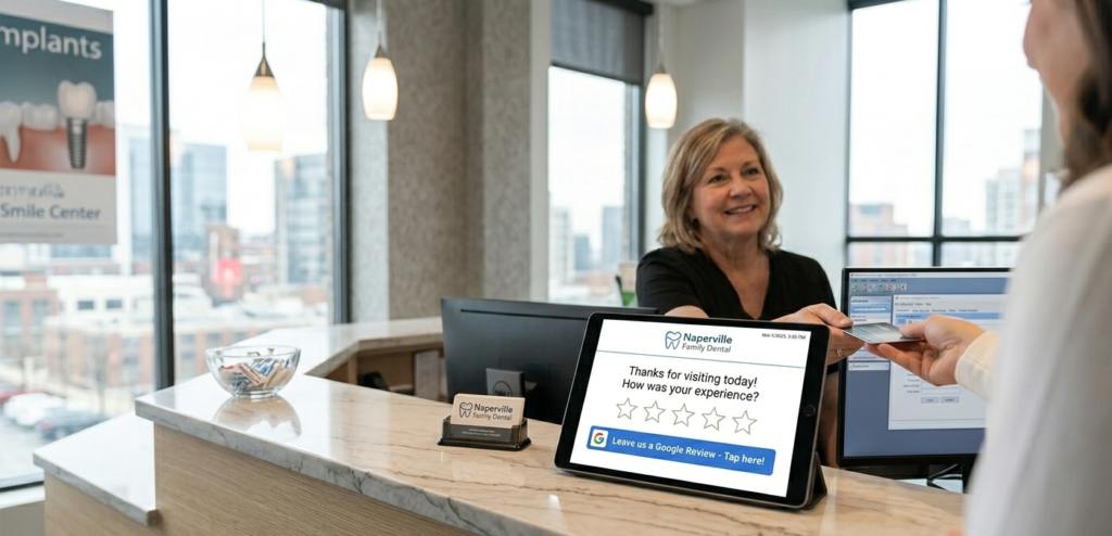 Dental practice reception desk with a tablet showing a post-appointment SMS review request linking to Google